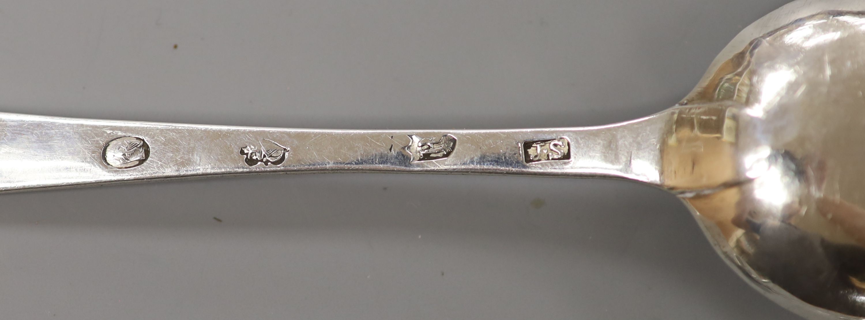 A George III Irish bright cut engraved silver tablespoon, John Shiels, Dublin, 1765 and two Victorian silver mustard spoons, 83 grams.